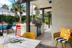 Covered Patio Adjacent To Outdoor Kitchen With Grill & Four Counter Stools